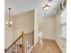 Upstairs hallway with hardwood floors and chandelier at 4187 Westchester Ne Trce, Roswell, GA 30075