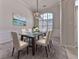 Elegant dining room with glass top table and chandelier at 4251 Sheffield Nw Ct, Kennesaw, GA 30144