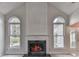 Elegant fireplace with a marble surround and arched windows at 4251 Sheffield Nw Ct, Kennesaw, GA 30144