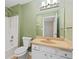 Full bathroom with light green walls and beige vanity at 1004 Masons Creek Cir # 1004, Atlanta, GA 30350