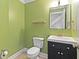 Small half bathroom with light green walls and dark vanity at 1004 Masons Creek Cir # 1004, Atlanta, GA 30350