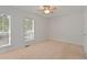 Well-lit bedroom with neutral decor and carpet at 1004 Masons Creek Cir # 1004, Atlanta, GA 30350