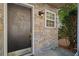 Dark brown front door with a brass door knocker and stone surround at 1004 Masons Creek Cir # 1004, Atlanta, GA 30350