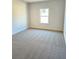 Bright bedroom featuring neutral carpeting and a window at 168 Silvercrest Dr, Acworth, GA 30101