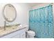 Bathroom with granite vanity, glass sink, and teal shower curtain at 2024 Gramercy Cir, Atlanta, GA 30341