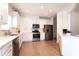 Modern kitchen with white cabinets, stainless steel appliances, and quartz countertops at 2024 Gramercy Cir, Atlanta, GA 30341