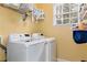 Bright laundry room with washer, dryer, and ample shelving at 2024 Gramercy Cir, Atlanta, GA 30341