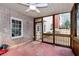 Screened porch with brick walls and ceiling fan at 2024 Gramercy Cir, Atlanta, GA 30341