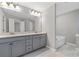 Double vanity bathroom with gray cabinets and a soaking tub at 372 Provenance Dr, Sandy Springs, GA 30328