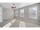 Well-lit bedroom featuring three windows and neutral decor at 372 Provenance Dr, Sandy Springs, GA 30328