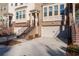 Townhouse exterior with brick facade, attached garage, and stairs at 372 Provenance Dr, Sandy Springs, GA 30328