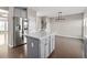 Kitchen island with white quartz countertop and gray cabinets at 372 Provenance Dr, Sandy Springs, GA 30328