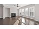 Spacious living room with hardwood floors, fireplace, and large windows at 372 Provenance Dr, Sandy Springs, GA 30328