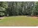 Large backyard with shed and wooded area at 45 Highland Park Way, Sharpsburg, GA 30277