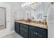 Bathroom with dark blue vanity cabinets and granite countertops at 45 Highland Park Way, Sharpsburg, GA 30277