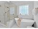 Spa-like bathroom featuring a freestanding tub and a large glass shower at 45 Highland Park Way, Sharpsburg, GA 30277