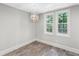 Bright dining room with wood-look tile floor and modern chandelier at 45 Highland Park Way, Sharpsburg, GA 30277