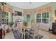 Bright dining room with a wooden table and chairs, and a built-in brick fireplace at 45 Highland Park Way, Sharpsburg, GA 30277