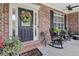 Front porch with rocking chairs and wreath on door at 45 Highland Park Way, Sharpsburg, GA 30277