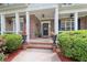 Brick front porch with rocking chairs and landscaping at 45 Highland Park Way, Sharpsburg, GA 30277