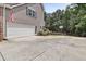 Two-car garage with driveway and basketball court at 45 Highland Park Way, Sharpsburg, GA 30277