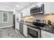 Modern kitchen with stainless steel appliances and tile floor at 45 Highland Park Way, Sharpsburg, GA 30277