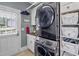 Bright laundry room with washer, dryer, and storage at 45 Highland Park Way, Sharpsburg, GA 30277