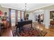 Bright living room with hardwood floors and a grand piano at 45 Highland Park Way, Sharpsburg, GA 30277