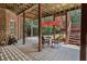 Covered patio with seating area, brick house, and wooded backdrop at 45 Highland Park Way, Sharpsburg, GA 30277