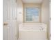 Relaxing bathroom with corner bathtub and neutral colors at 80 Valley Dr, Stockbridge, GA 30281