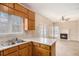 Kitchen with wood cabinets, double sink, and view into Gathering room at 80 Valley Dr, Stockbridge, GA 30281