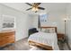 Bright bedroom with a queen bed, dresser, and exposed brick wall at 856 Briarcliff Ne Rd # 25, Atlanta, GA 30306