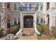 Elegant entryway with a dark door, stone steps, and landscaping at 856 Briarcliff Ne Rd # 25, Atlanta, GA 30306