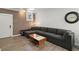 Basement living room with gray sectional sofa and exposed brick wall at 856 Briarcliff Ne Rd # 25, Atlanta, GA 30306