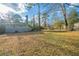 Another backyard view with tree stump, trees, and single story home at 2802 Mcafee Rd, Decatur, GA 30032