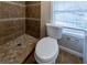 Stylish bathroom with tiled walk-in shower, tiled floors, and a large window at 2802 Mcafee Rd, Decatur, GA 30032