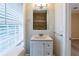 Well-lit bathroom featuring tile shower, modern vanity, mirror, and window at 2802 Mcafee Rd, Decatur, GA 30032