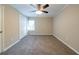Spacious bedroom with a ceiling fan, neutral paint, plush carpet and a window with blinds at 2802 Mcafee Rd, Decatur, GA 30032