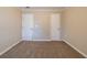 Neutral bedroom featuring carpet floors and neutral walls with two doors in the space at 2802 Mcafee Rd, Decatur, GA 30032