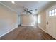 Cozy living room with neutral paint, plush carpeting, ceiling fan, and natural light at 2802 Mcafee Rd, Decatur, GA 30032