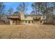 Exterior back view showing a yellow house with a spacious back yard and multiple decks at 4741 W Lake Se Dr, Conyers, GA 30094