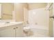 Bathroom features shower-tub combo with tiled walls and hexagon tile flooring at 4741 W Lake Se Dr, Conyers, GA 30094