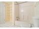 Full bathroom with a tub, shower and toilet next to open shelving for optimal organization at 4741 W Lake Se Dr, Conyers, GA 30094