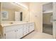 Bathroom featuring double vanity with large mirror and views into main bedroom at 4741 W Lake Se Dr, Conyers, GA 30094
