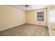 Bedroom featuring neutral walls, carpet flooring, ceiling fan and a single window for natural light at 4741 W Lake Se Dr, Conyers, GA 30094