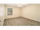 Bedroom features neutral walls, carpet flooring, ceiling fan, closet, and a single window at 4741 W Lake Se Dr, Conyers, GA 30094