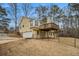 Exterior showcasing a yellow house with a two car garage and spacious second floor deck at 4741 W Lake Se Dr, Conyers, GA 30094