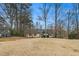 Lovely yellow house with a large front lawn and mature trees at 4741 W Lake Se Dr, Conyers, GA 30094