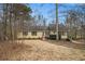 Charming single-story home with yellow siding, mature trees, and inviting front entrance at 4741 W Lake Se Dr, Conyers, GA 30094
