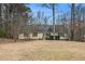 Charming single-story home with yellow siding, mature trees, and inviting front entrance at 4741 W Lake Se Dr, Conyers, GA 30094